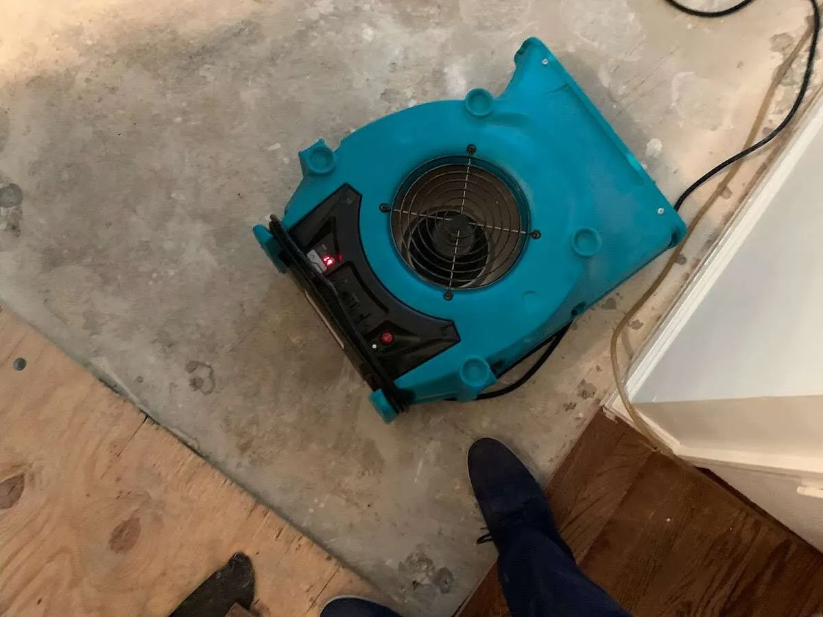 Air mover drying subfloor during Commercial Water Damage Restoration in Plover